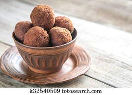 Bowl of meatballs on the wooden background