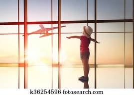 girl looks at a plane at the airport girl looks at a plane at the airport