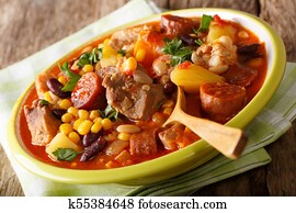 Cape Verde food cachupa with meat, sausages and vegetables close-up in a plate. horizontal