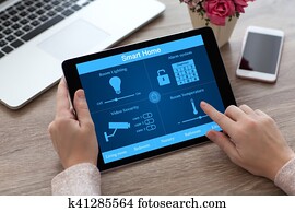 woman hands holding tablet PC computer smart home near laptop