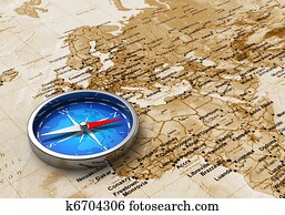 Blue metal compass on the old world map