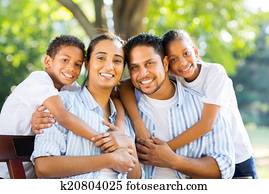 young indian family sitting in the park young indian family sitting in the park