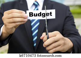 businessman with scissors cutting label Budget