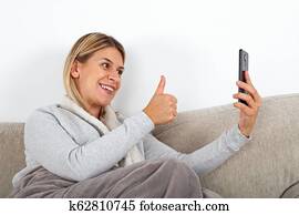 Casual guy with smartphone showing online stuff to friends while