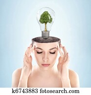 Open minded woman with green energy symbol