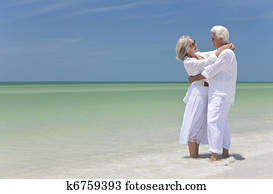 Happy Senior Couple Embracing on A Tropical Beach