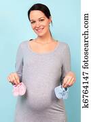 Pregnant woman holding baby booties