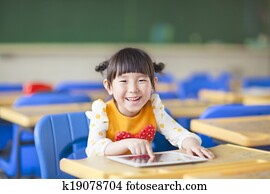 smiling kid using tablet or ipad smiling kid using tablet or ipad