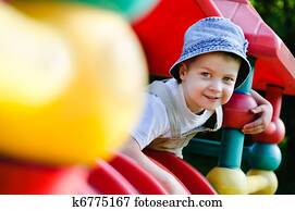 young autistic boy playing on playground young autistic boy playing on playground