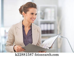 Happy business woman with documents in office