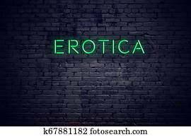 Brick wall at night with neon sign erotica Brick wall at night with neon sign erotica