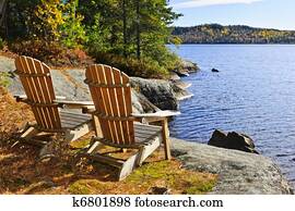 Adirondack chairs at lake shore Adirondack chairs at lake shore