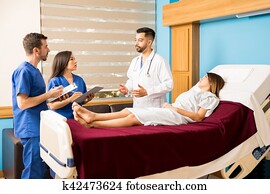 Doctor explaining case to residents