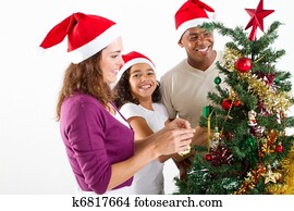 family decorating Christmas tree