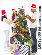 family decorating Christmas tree