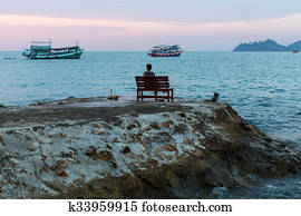 Lonely woman sitting on a bench 