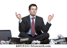 Stressed, frustrated business man meditates in office at desk