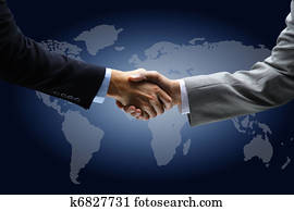 Handshake with map of the world in background 