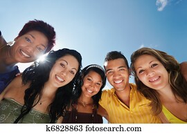 team of man and women embracing, smiling at camera