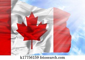 Canada waving flag against blue sky with sunrays Canada waving flag against blue sky with sunrays