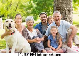 Extended family with their pet dog at park