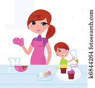 Happy mother with her son cooking in the kitchen Happy mother with her son cooking in the kitchen