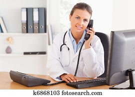 Serious female doctor on the phone