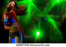 Beautiful young woman dancing in the nightclub
