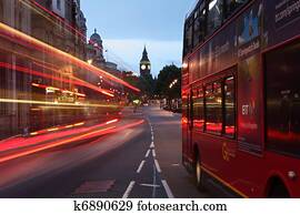 Big Ben and buses at dawn in London city England