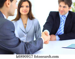 Business people shaking hands, finishing up a meeting Business people shaking hands, finishing up a meeting