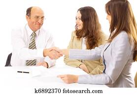 Business people shaking hands, finishing up a meeting 