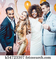 Couples in a club celebrating new years eve dancing into midnigh