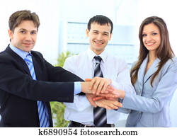 Image of business people hands on top of each other symbolizing support and power 