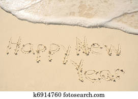 Happy New Year Written in Sand on Beach