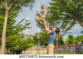 Dad and son on background of Fort Cornwallis in Georgetown, Penang, is a star fort built by the British East India Company in the late 18th century, it is the largest standing fort in Malaysia. Traveling with children concept