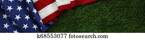 Red, white, and blue American flag on grass for Memorial Day or Veteran's day background Red, white, and blue American flag on grass for Memorial Day or Veteran's day background
