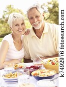 Senior Couple Enjoying Meal In Garden