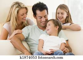 Family sitting in living room smiling Family sitting in living room smiling