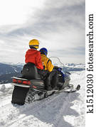 Couple on snowmobile.