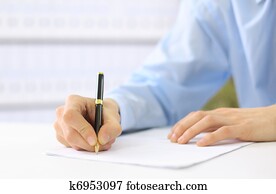 Hands writing on a paper Hands writing on a paper