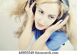 woman singing with headphones isolated on light background