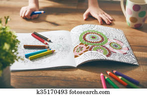 Child paint a coloring book