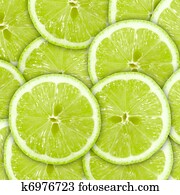 Abstract green background with citrus-fruit of lime slices
