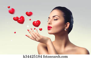 Beauty woman with perfect make up blowing valentine hearts Beauty woman with perfect make up blowing valentine hearts