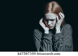 Fearful woman covering her ears