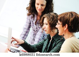 While  meeting, group of young women working together on the table
