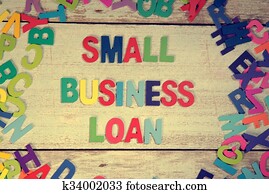 small business loan word block concept photo on plank wood