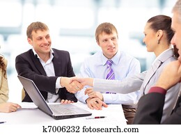 Business people shaking hands, finishing up a meeting Business people shaking hands, finishing up a meeting