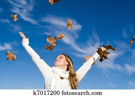 autumn woman arms raised in happiness