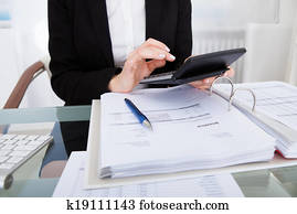 Businesswoman Calculating Bills